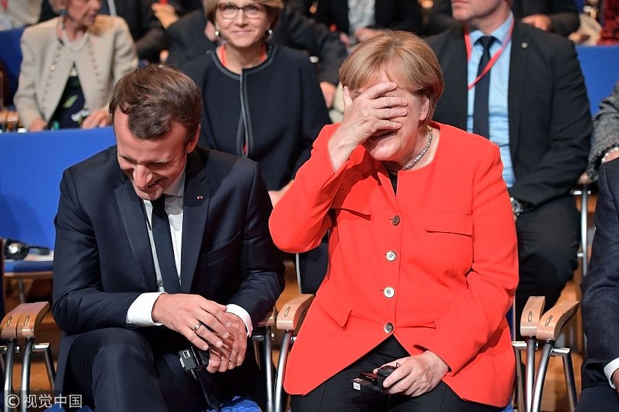 This image has an empty alt attribute; its file name is Merkel-Macron-laughing.jpg